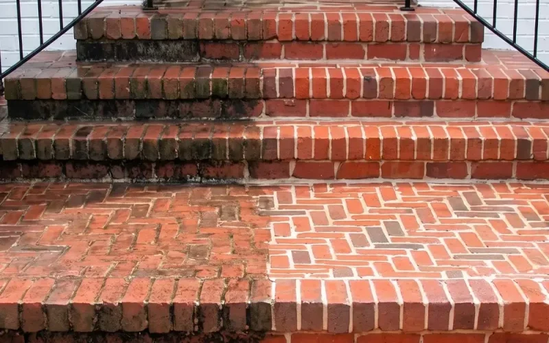 Brick steps and patio showing the results of professional pressure washing